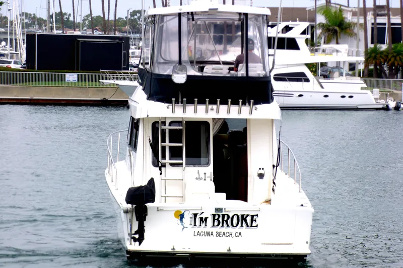 Slide: The Image of 2003 Mediterranean 38 Convertible boat named "I'm Broke" in a marina. - 6