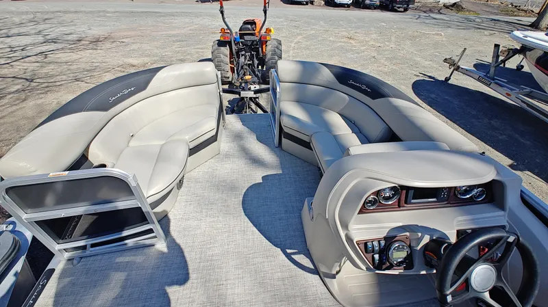 Slide: The Image of 2022 South Bay 200 Series S222RS 2.75 pontoon boat interior with seating and control panel. - 12