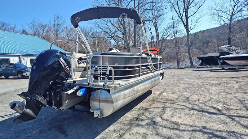 Slide: The Image of 2022 South Bay 200 Series S222RS pontoon boat with Mercury outboard motor, parked outdoors. - 5