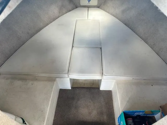 Slide: The Image of Interior cabin of a 2001 Parker 2510DVWA boat with cushioned seating. - 10