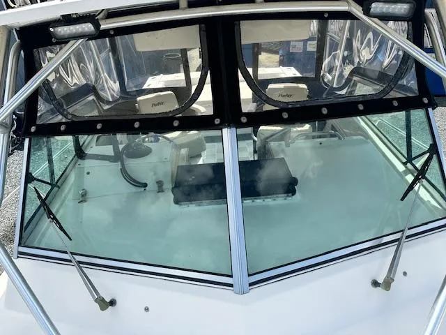 Slide: The Image of 2001 Parker 2510DVWA boat windshield and cockpit view with wipers and clear enclosure. - 11