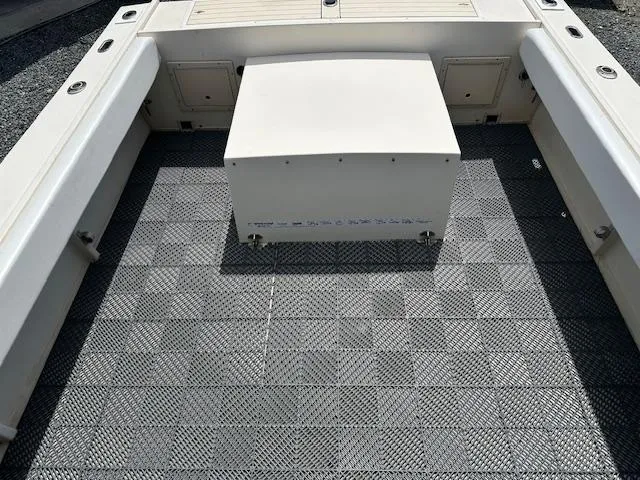 Slide: The Image of 2001 Parker 2510DVWA boat interior with checkered flooring and storage compartments. - 16