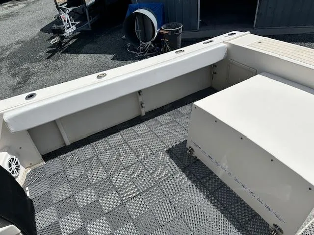 Slide: The Image of 2001 Parker 2510DVWA boat deck with seating and storage, featuring a checkered floor pattern. - 18