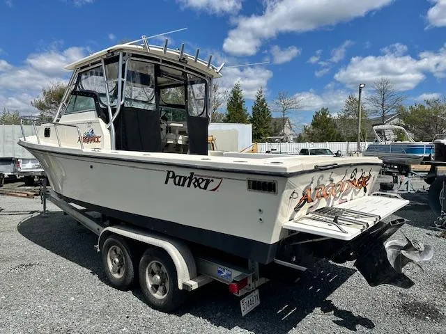 Slide: The Image of 2001 Parker 2510DVWA boat on trailer under blue sky with clouds. - 3