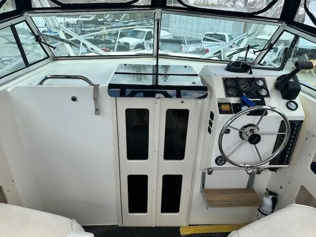 Slide: The Image of 2001 Parker 2510DVWA boat helm with steering wheel and control panel. - 4