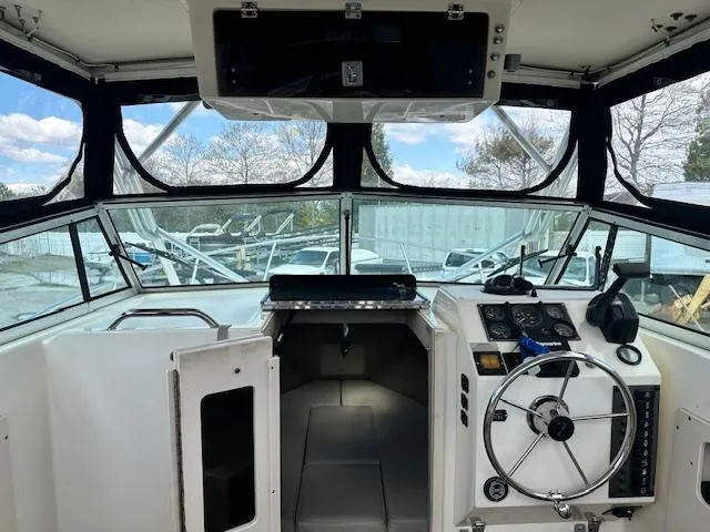 Slide: The Image of Interior view of 2001 Parker 2510DVWA boat cockpit with steering wheel and controls. - 5
