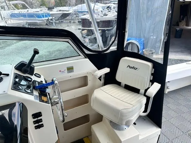 Slide: The Image of Interior of a 2001 Parker 2510DVWA boat with steering wheel and captain's chair. - 7