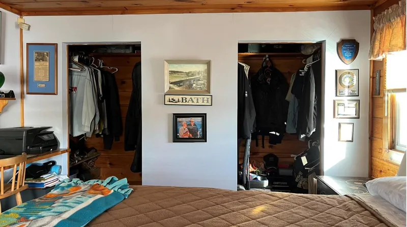 Slide: The Image of Cozy houseboat bedroom with wooden accents, dual closets, and framed wall art. - 13