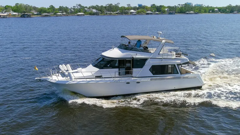 Slide: The Image of 1997 Navigator 5600 Sundance Pilothouse yacht cruising on a calm lake. - 10