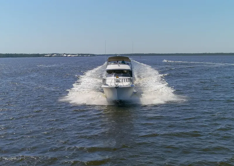 Slide: The Image of 1997 Navigator 5600 Sundance Pilothouse cruising on open water, leaving a wake behind. - 11