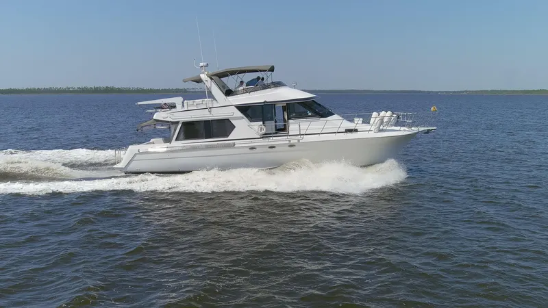 Slide: The Image of 1997 Navigator 5600 Sundance Pilothouse cruising on open water. - 13