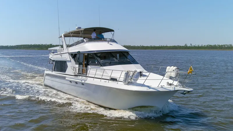 Slide: The Image of 1997 Navigator 5600 Sundance Pilothouse yacht cruising on open water. - 19