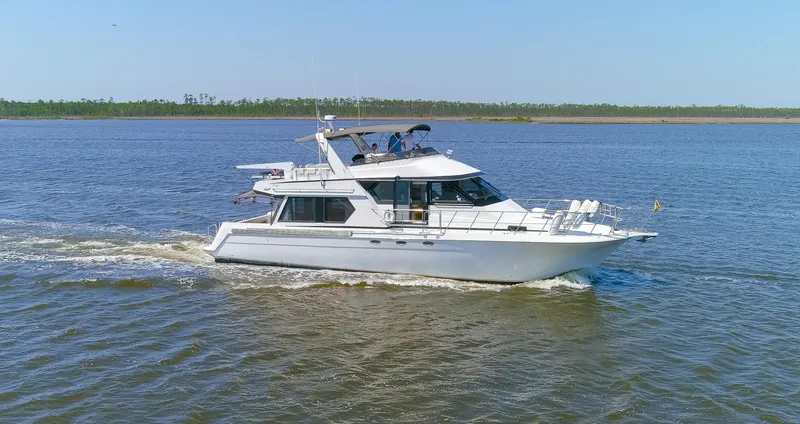 Slide: The Image of 1997 Navigator 5600 Sundance Pilothouse yacht cruising on open water. - 26