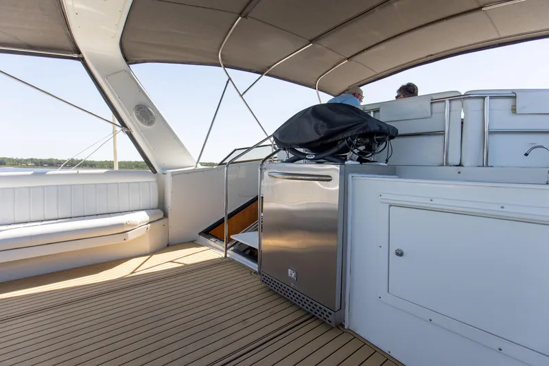 Slide: The Image of Spacious deck of 1997 Navigator 5600 Sundance Pilothouse with seating and storage. - 30