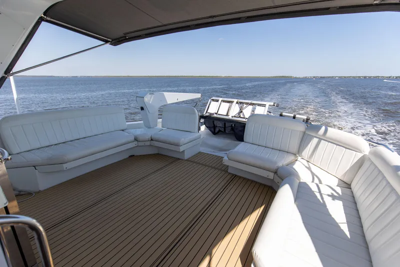 Slide: The Image of Spacious deck of 1997 Navigator 5600 Sundance Pilothouse yacht with white seating and ocean view. - 31