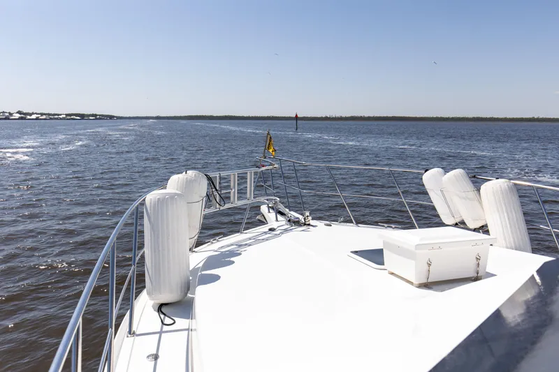 Slide: The Image of 1997 Navigator 5600 Sundance Pilothouse cruising on open water under clear skies. - 35