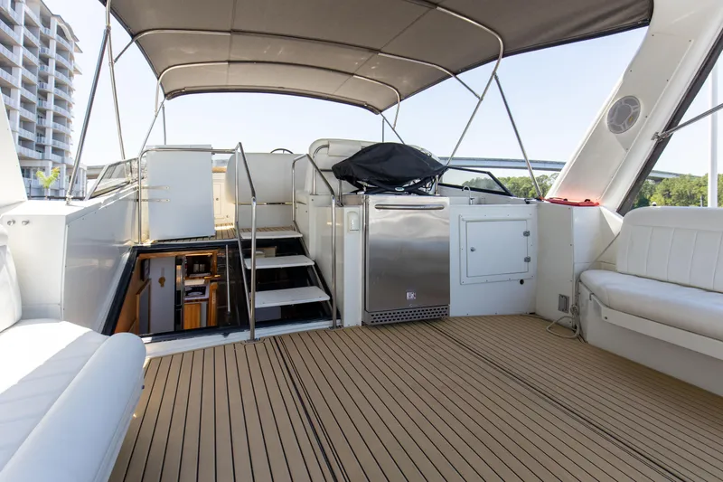 Slide: The Image of 1997 Navigator 5600 Sundance Pilothouse yacht interior with seating, stairs, and canopy. - 36