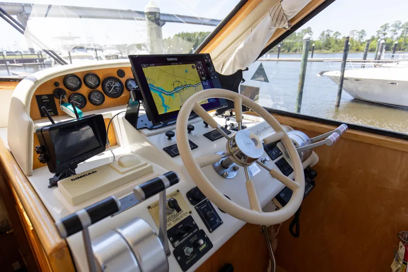 Slide: The Image of 1997 Navigator 5600 Sundance Pilothouse helm with navigation equipment and steering wheel. - 39