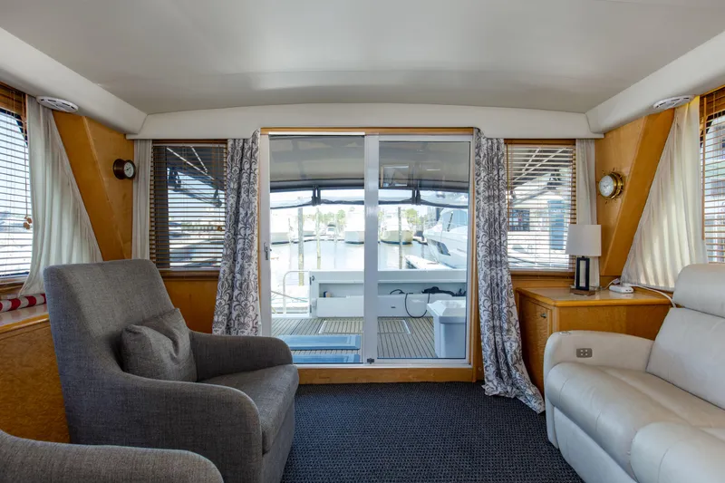 Slide: The Image of Interior of 1997 Navigator 5600 Sundance Pilothouse yacht with comfortable seating and marina view. - 45