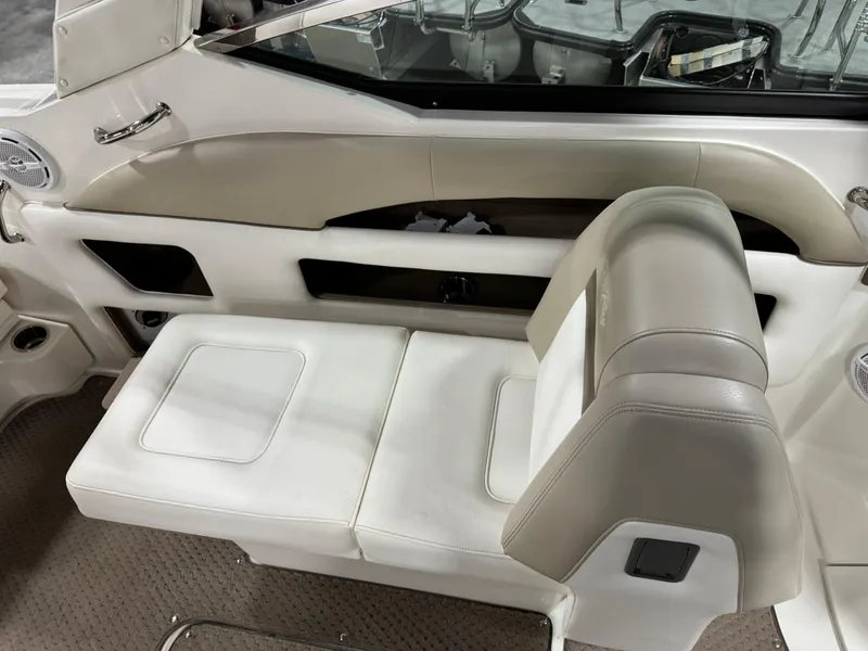 Slide: The Image of Interior seating of a 2013 Sea Ray 300 SLX boat, featuring white and beige upholstery. - 11