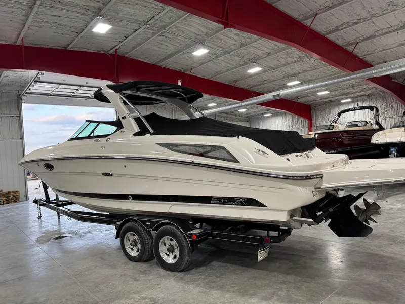 Slide: The Image of 2013 Sea Ray 300 SLX boat on trailer in indoor storage facility. - 16