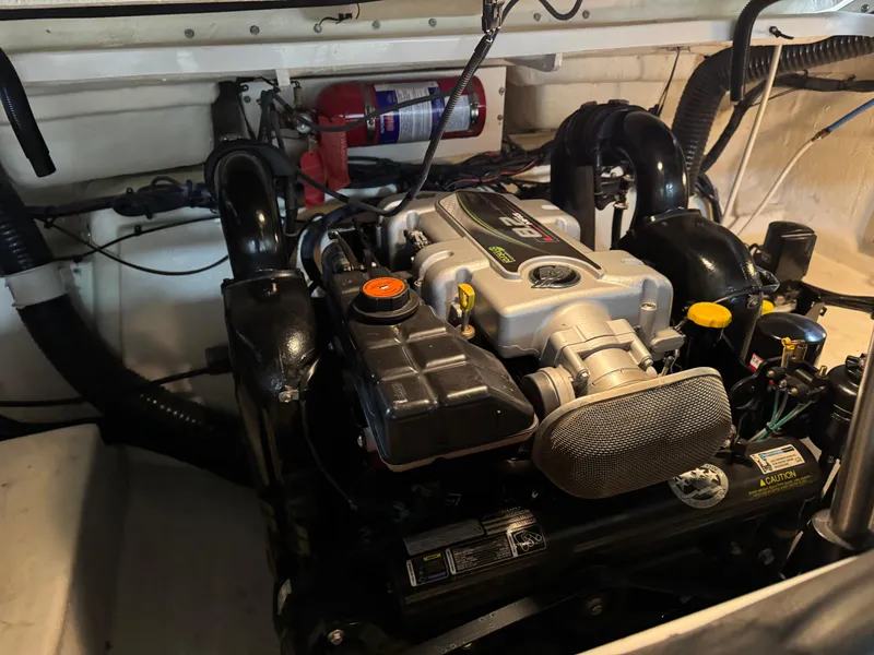 Slide: The Image of Engine compartment of a 2013 Sea Ray 300 SLX boat, featuring a well-maintained motor. - 18