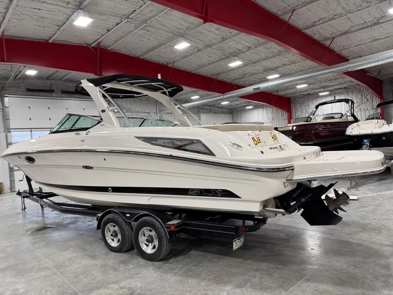Slide: The Image of 2013 Sea Ray 300 SLX boat on trailer in indoor storage facility. - 3