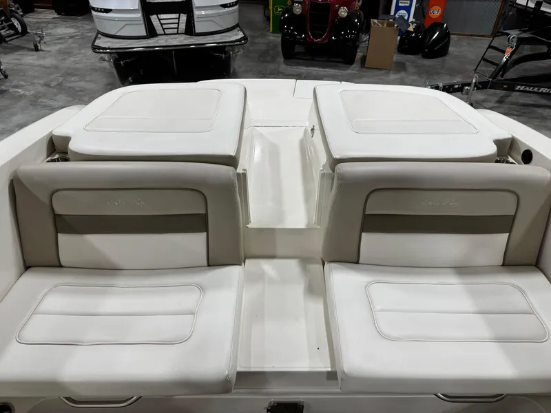 Slide: The Image of 2013 Sea Ray 300 SLX boat interior with white cushioned seating. - 9