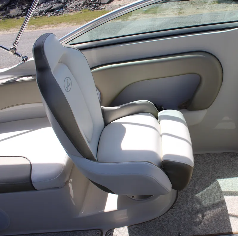 Slide: The Image of Captain's chair on a 2007 Sea Ray 240 Sundeck boat interior. - 11