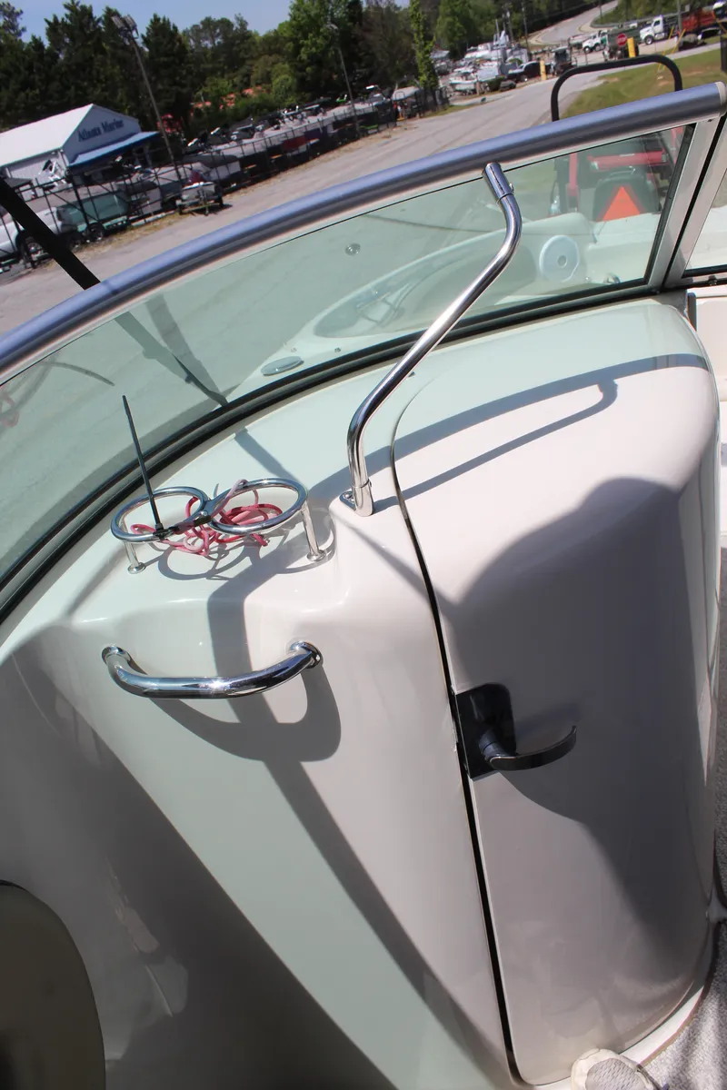 Slide: The Image of 2007 Sea Ray 240 Sundeck boat interior with dashboard and railing. - 12