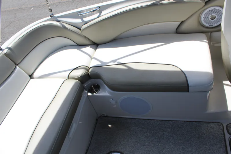 Slide: The Image of 2007 Sea Ray 240 Sundeck interior seating with cushioned upholstery and built-in speaker. - 14
