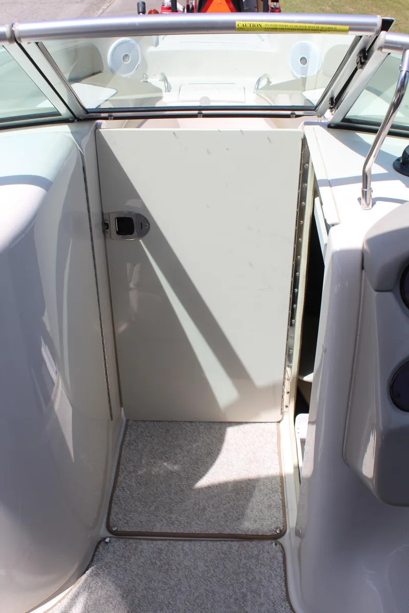 Slide: The Image of 2007 Sea Ray 240 Sundeck interior with open cabin door, showcasing boat's entryway. - 18