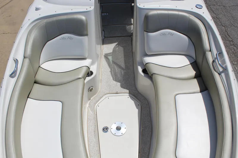 Slide: The Image of 2007 Sea Ray 240 Sundeck boat interior with cushioned seating and sleek design. - 22