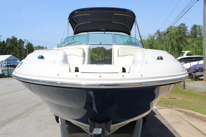 Slide: The Image of 2007 Sea Ray 240 Sundeck boat with canopy, parked on a trailer, front view. - 4