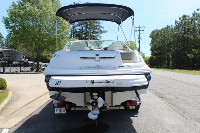 Slide: The Image of 2007 Sea Ray 240 Sundeck boat with canopy, parked on a sunny day. - 5