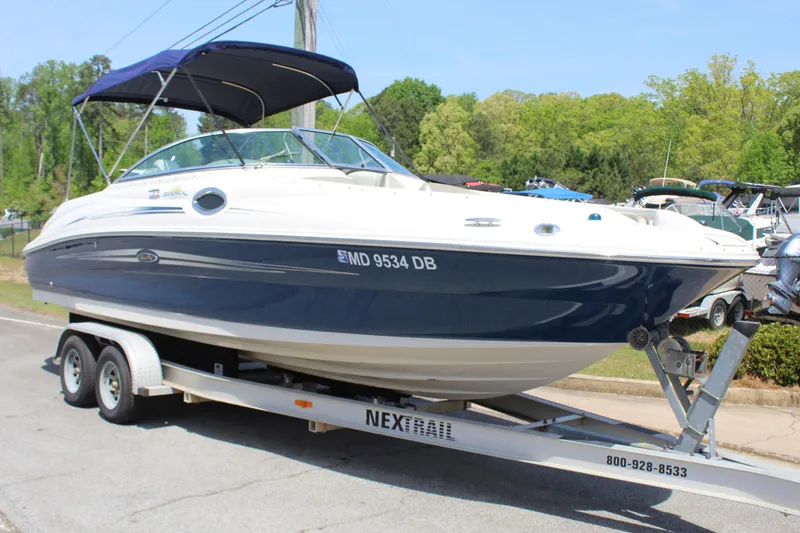 Slide: The Image of 2007 Sea Ray 240 Sundeck boat on trailer, parked outdoors. - 8