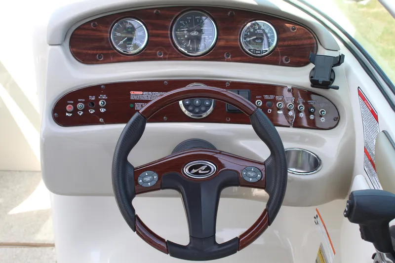 Slide: The Image of Dashboard of a 2007 Sea Ray 240 Sundeck boat with steering wheel and gauges. - 9