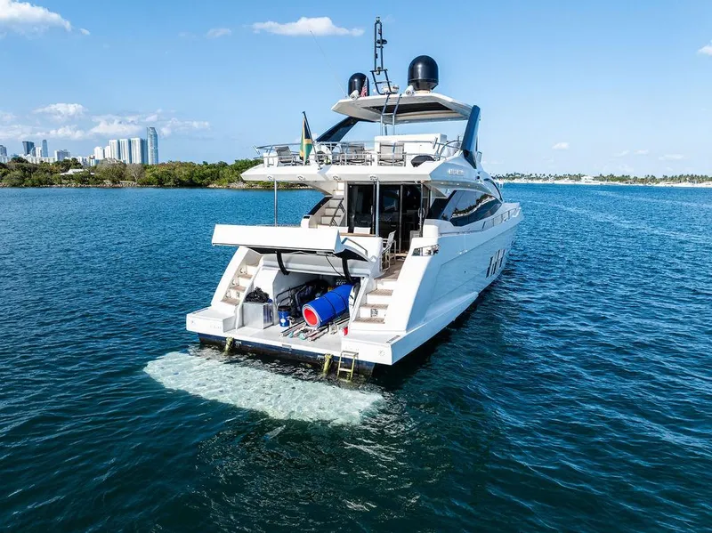 Slide: The Image of Astondoa 72 GLX yacht cruising on blue waters, 2013 model, city skyline in background. - 15