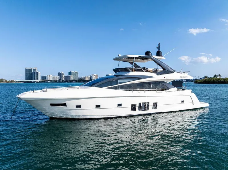 Slide: The Image of 2013 Astondoa 72 GLX yacht on calm water with city skyline in background. - 2