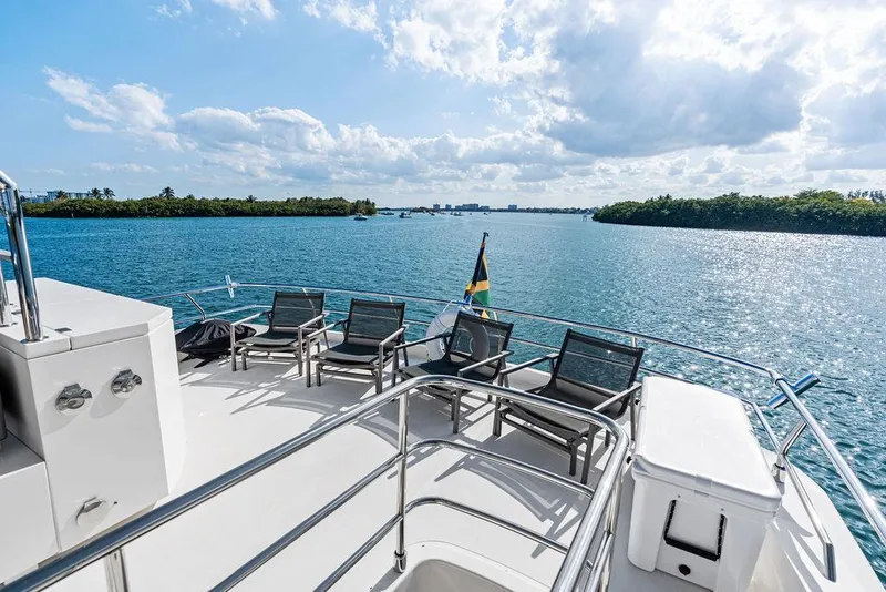 Slide: The Image of Astondoa 72 GLX yacht deck with lounge chairs, overlooking serene blue waters, 2013 model. - 23