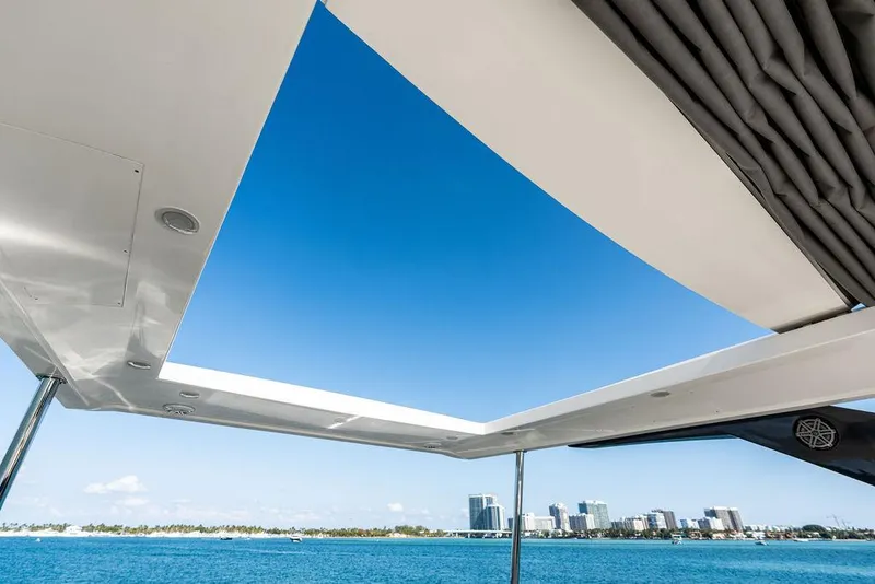 Slide: The Image of Astondoa 72 GLX yacht view, open sky roof, city skyline, blue sea, 2013 model. - 34