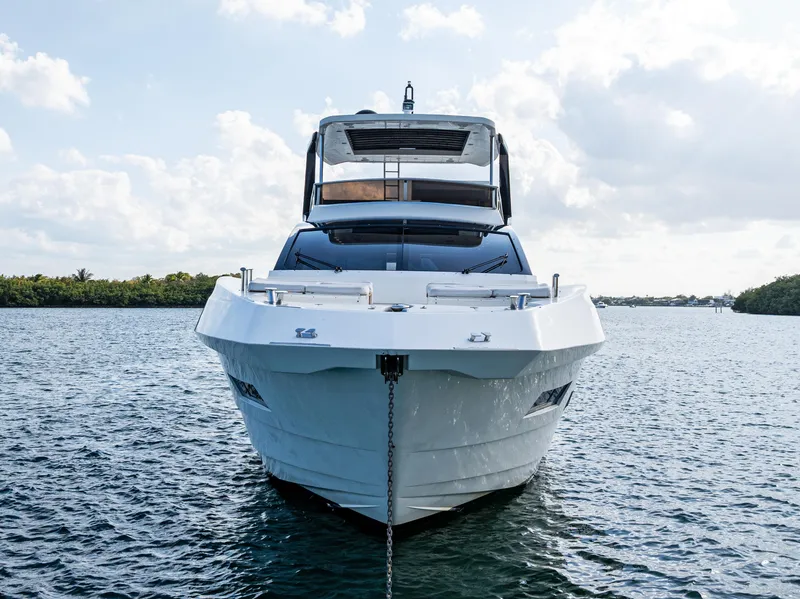 Slide: The Image of 2013 Astondoa 72 GLX yacht on water, front view, under a partly cloudy sky. - 8