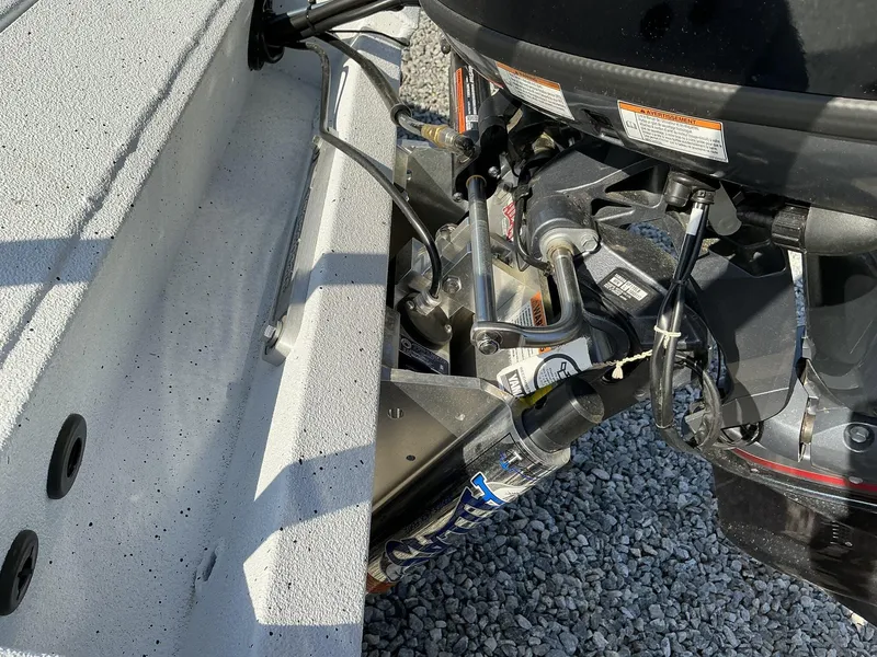 Slide: The Image of 2025 Xpress Skiff 185 boat engine and hydraulic system close-up. - 11