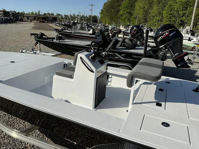 Slide: The Image of 2025 Xpress Skiff 185 boat with Yamaha motor, displayed outdoors on gravel lot. - 8