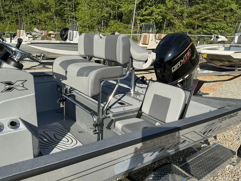 Slide: The Image of 2025 Xpress Hyper-Lift Series H20B boat with new console and seating, parked outdoors. - 7