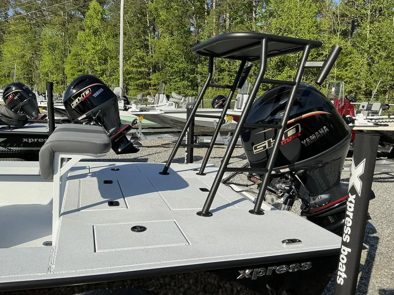 Slide: The Image of 2025 Xpress Skiff 185 boat with Yamaha outboard motor, displayed outdoors. - 6