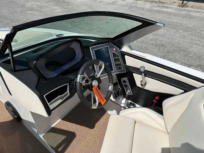 Slide: The Image of 2022 MasterCraft XT25 boat interior with modern dashboard and steering wheel. - 10