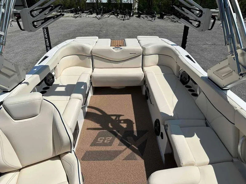 Slide: The Image of 2022 MasterCraft XT25 boat interior with luxurious white seating and modern design. - 15
