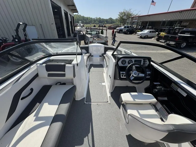 Slide: The Image of 2020 Yamaha AR210 boat interior with steering wheel, seating, and dashboard controls. - 10