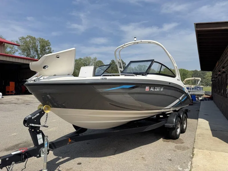 Slide: The Image of 2020 Yamaha AR210 boat on trailer, parked outdoors under clear sky. - 2